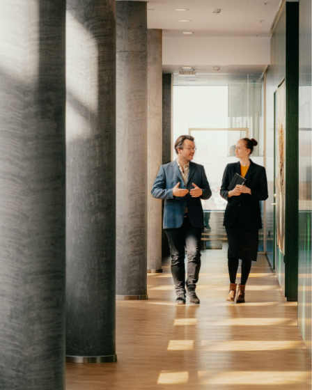 Business colleagues collaborating in a modern office hallway